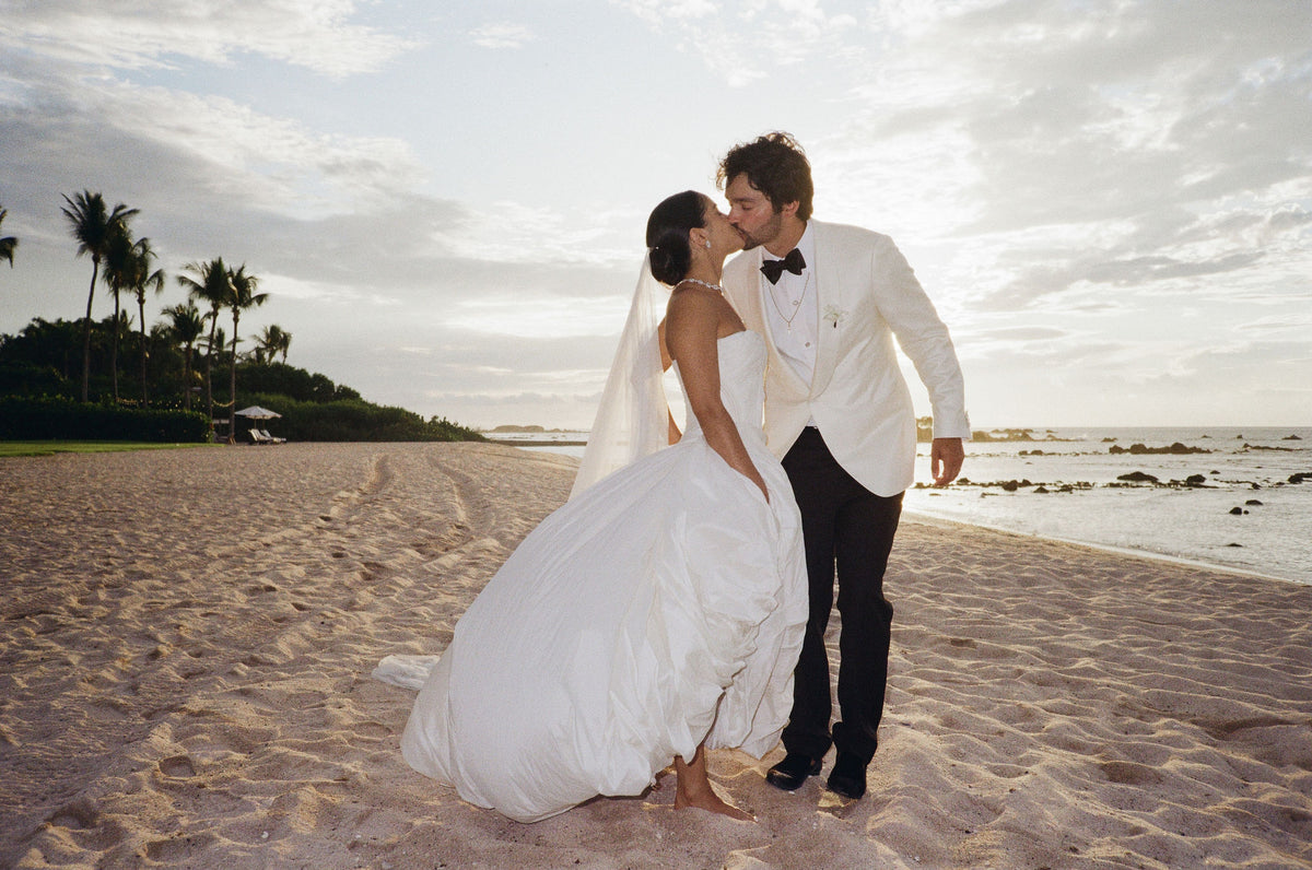Bride and groom kiss on a beach in Punta Mita at sunset