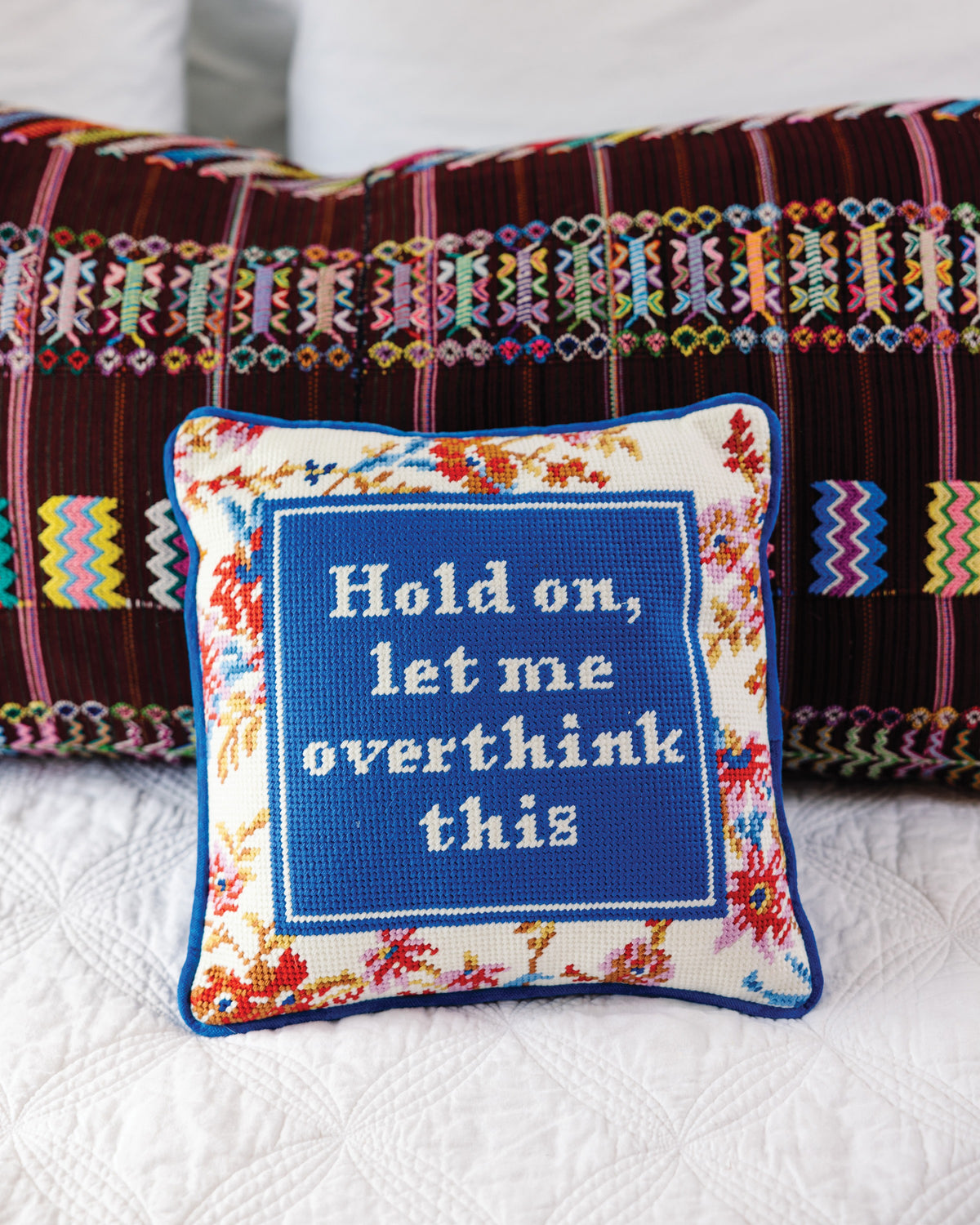 Overthink Needlepoint Pillow - styled on bed