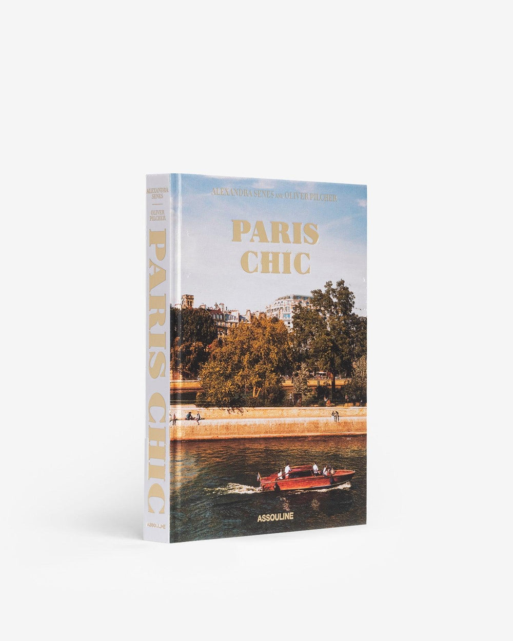 Three-quarter view of Paris Chic hardcover book showcasing a Paris riverfront cover photo and gold title on a white background