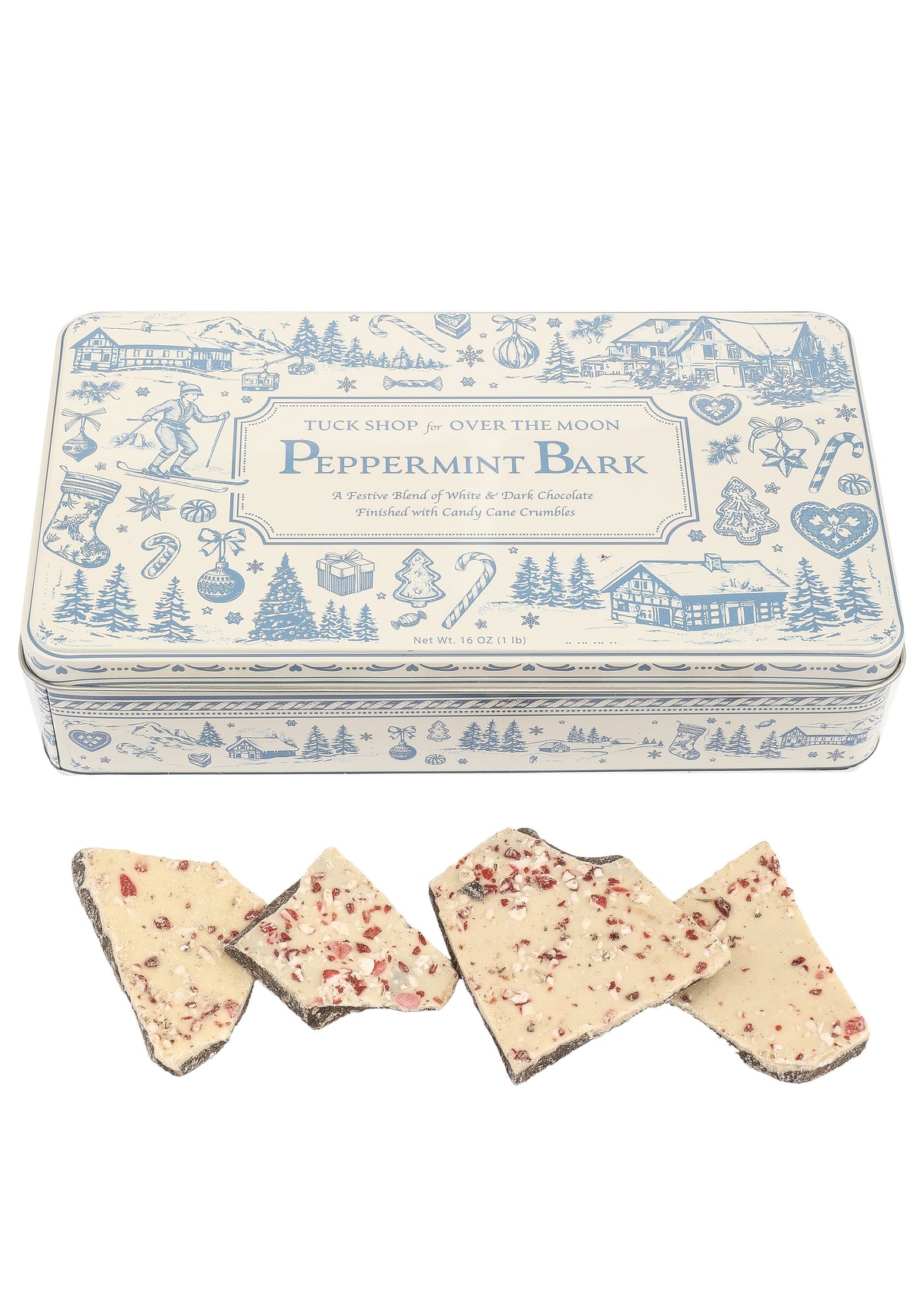 Angled view of Tuck Shop for Over The Moon peppermint bark with peppermint-topped chocolate pieces and keepsake tin