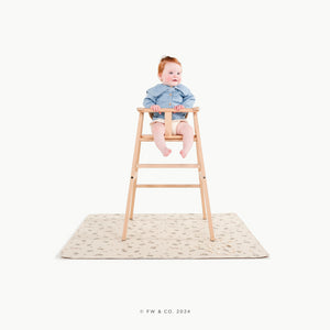 Peter Rabbitª@little girl in a high chair on a mat