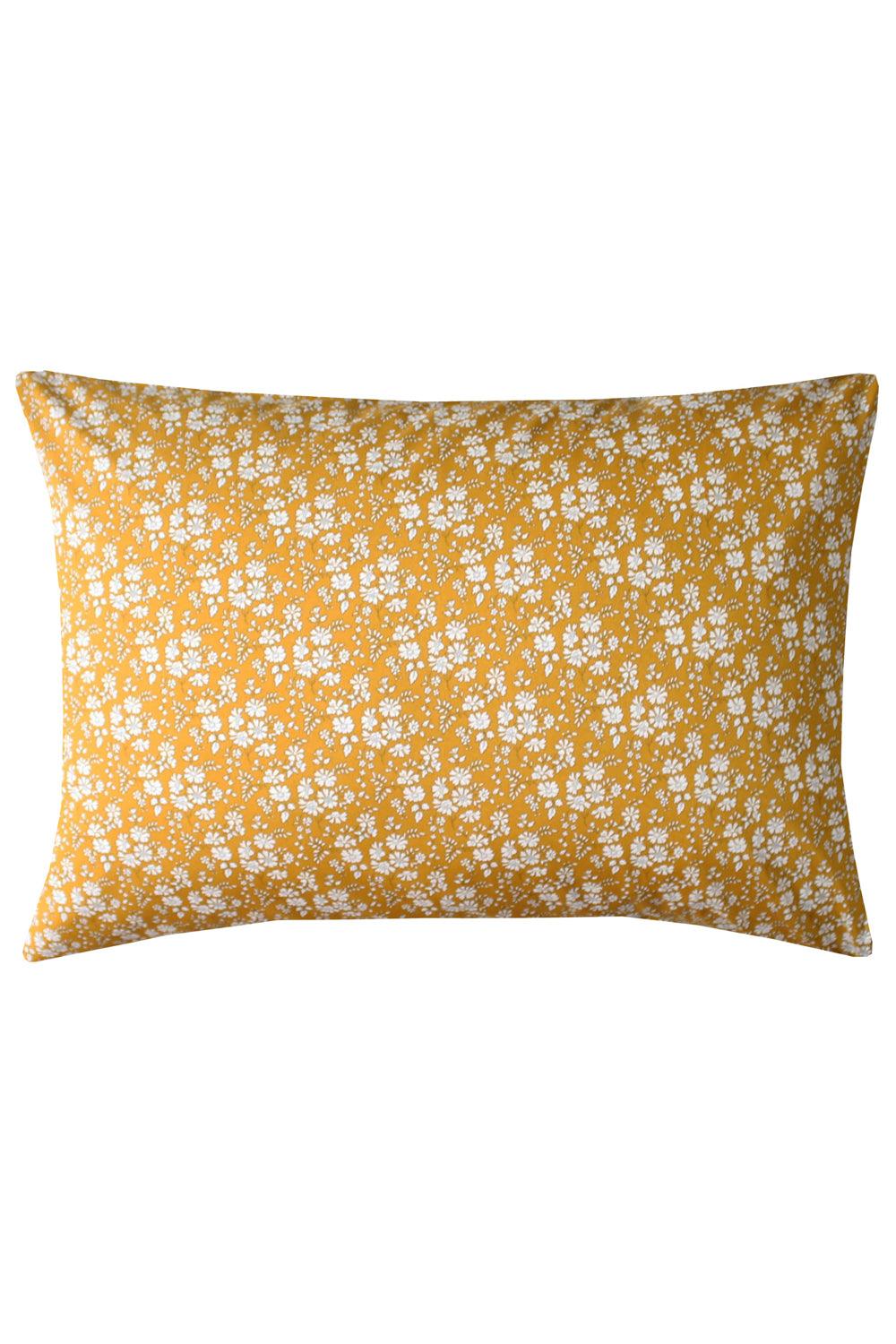 Front view of pillowcase made with Liberty Fabric in Capel Mustard showcasing a white floral pattern on mustard fabric