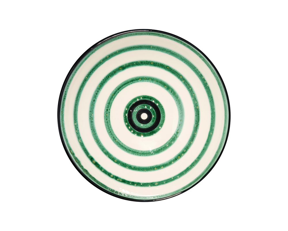 Top-down view of Bertie serving bowl showcasing green concentric rings pattern on white background
