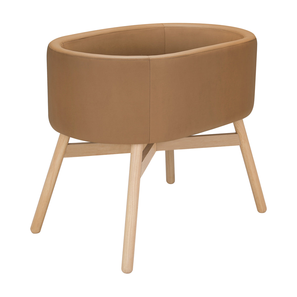 Three-quarter view of babyletto x GATHRE Capsule Bassinet in Camel showcasing rounded wood legs and open interior
