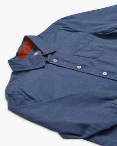 Blue shirt with a collar and button details on a white background