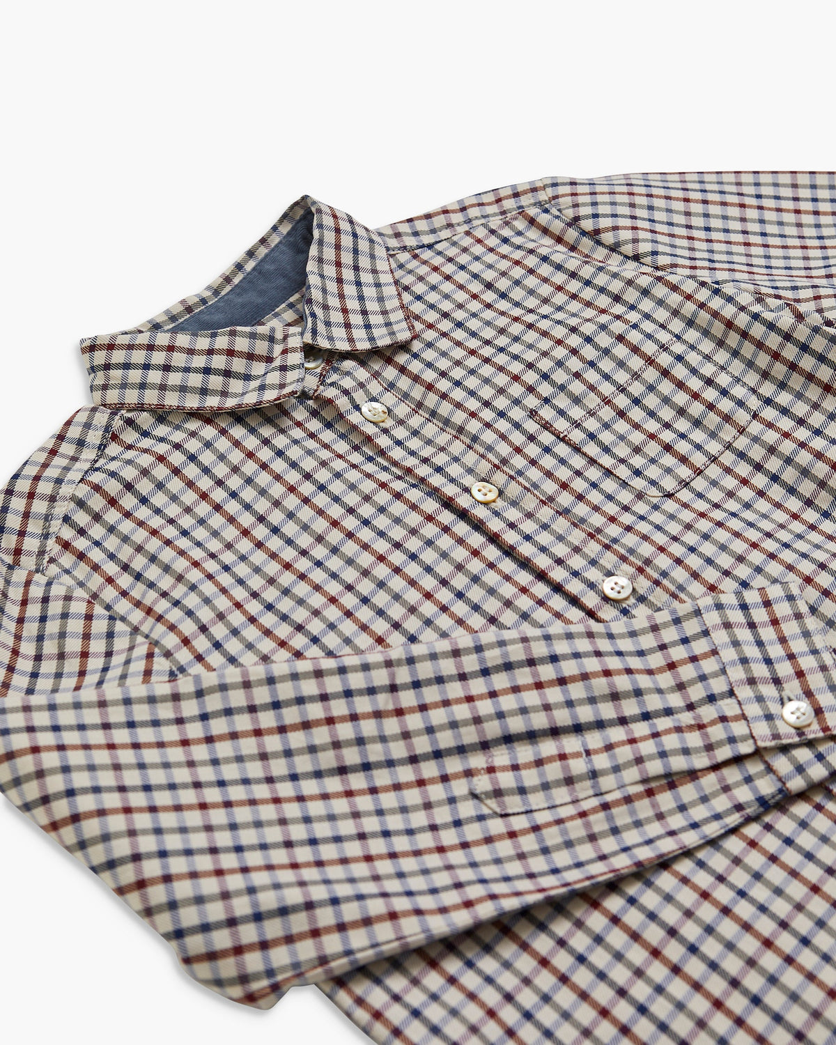 Folded plaid shirt on a white background