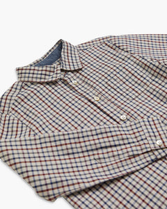 Folded plaid shirt on a white background