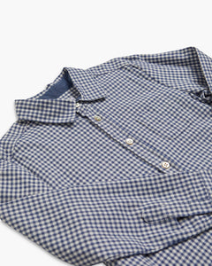 Folded blue and white checkered shirt on a white background