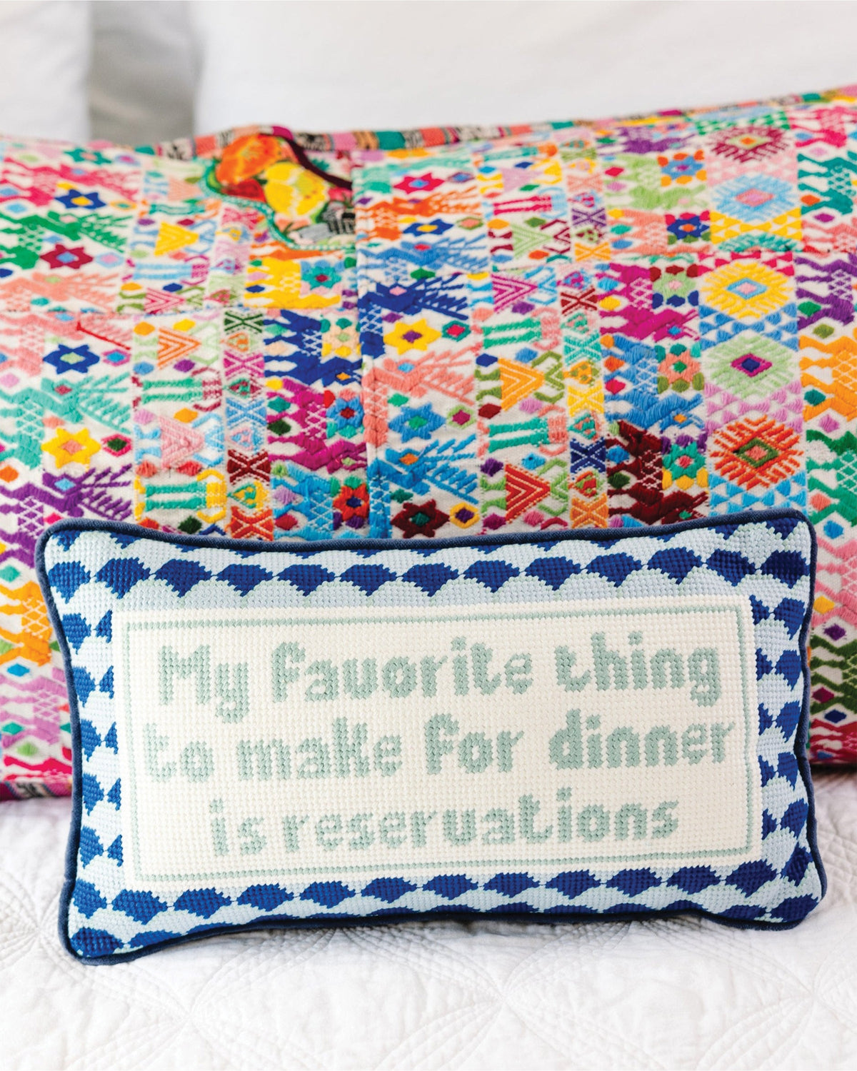 Reservations Needlepoint Pillow - styled on bed