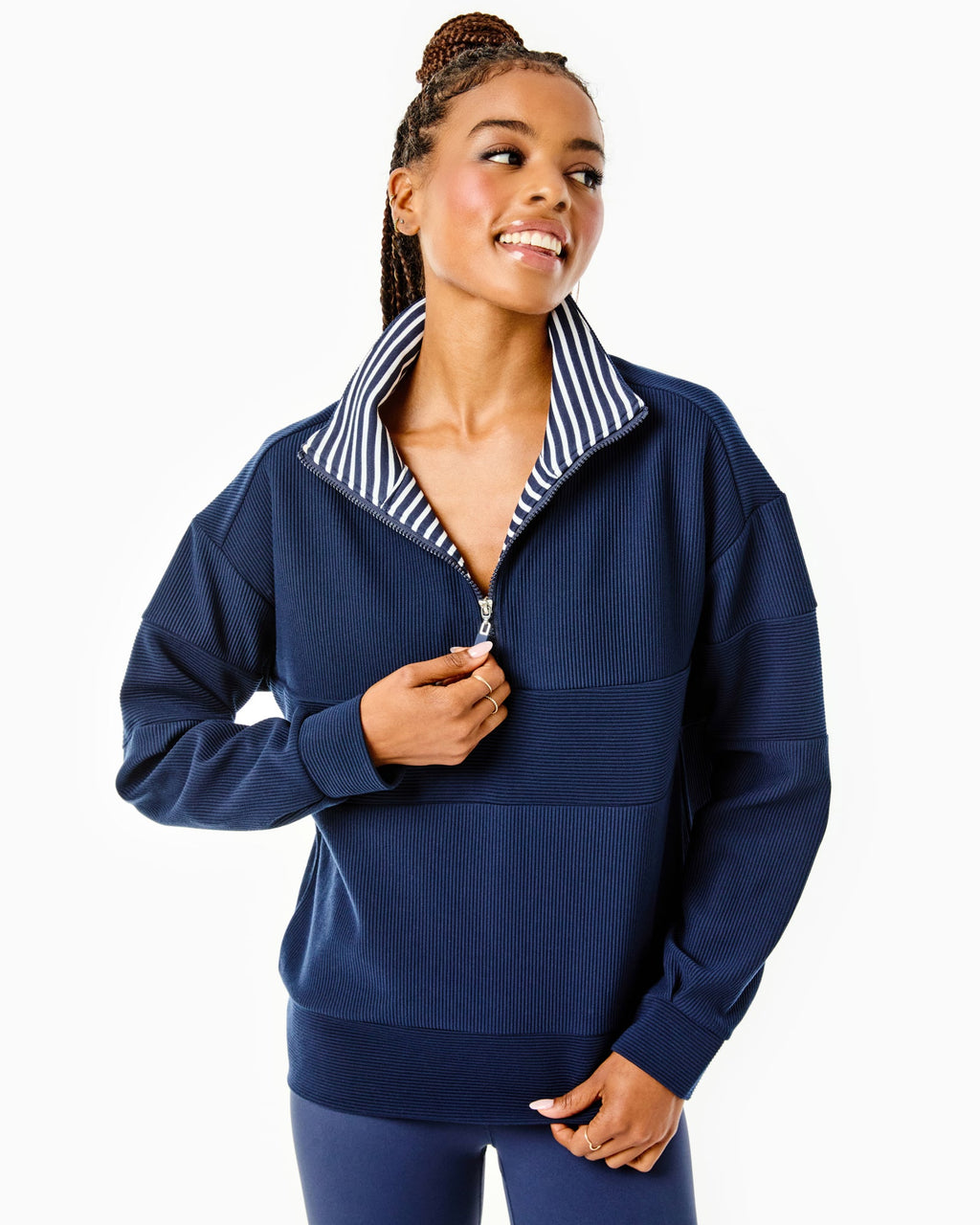 Model is wearing the Ribbed Varsity Quarter Zip in Navy over the Classic Short Sleeve in Super White/ Navy Stripe with the Flounce Skort in Navy/ Cherry Stars