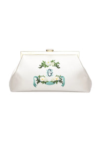 Personalized wedding accessory: White The Bella Rosa Collection clutch with floral embroidery and metal clasp.