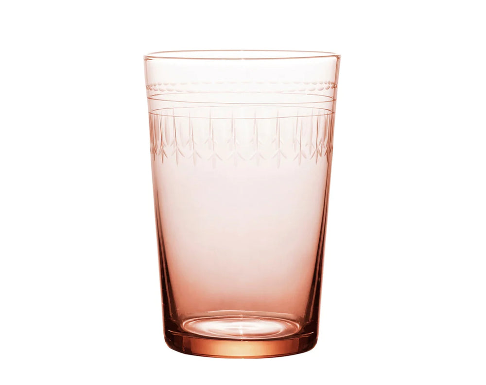 Front view of rose glass tumbler showcasing hand-engraved oval and geometric pattern on white background