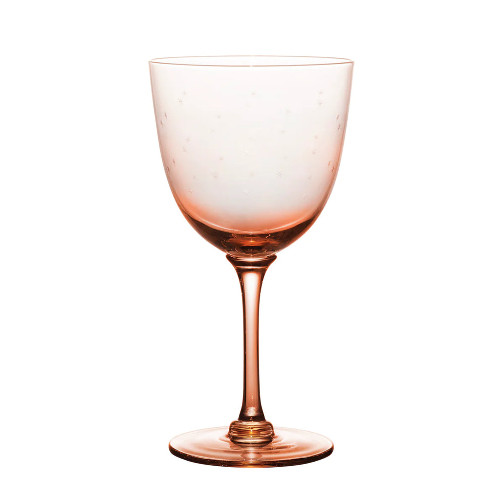 Front view of rose wine glass showcasing engraved star pattern on the bowl with white background