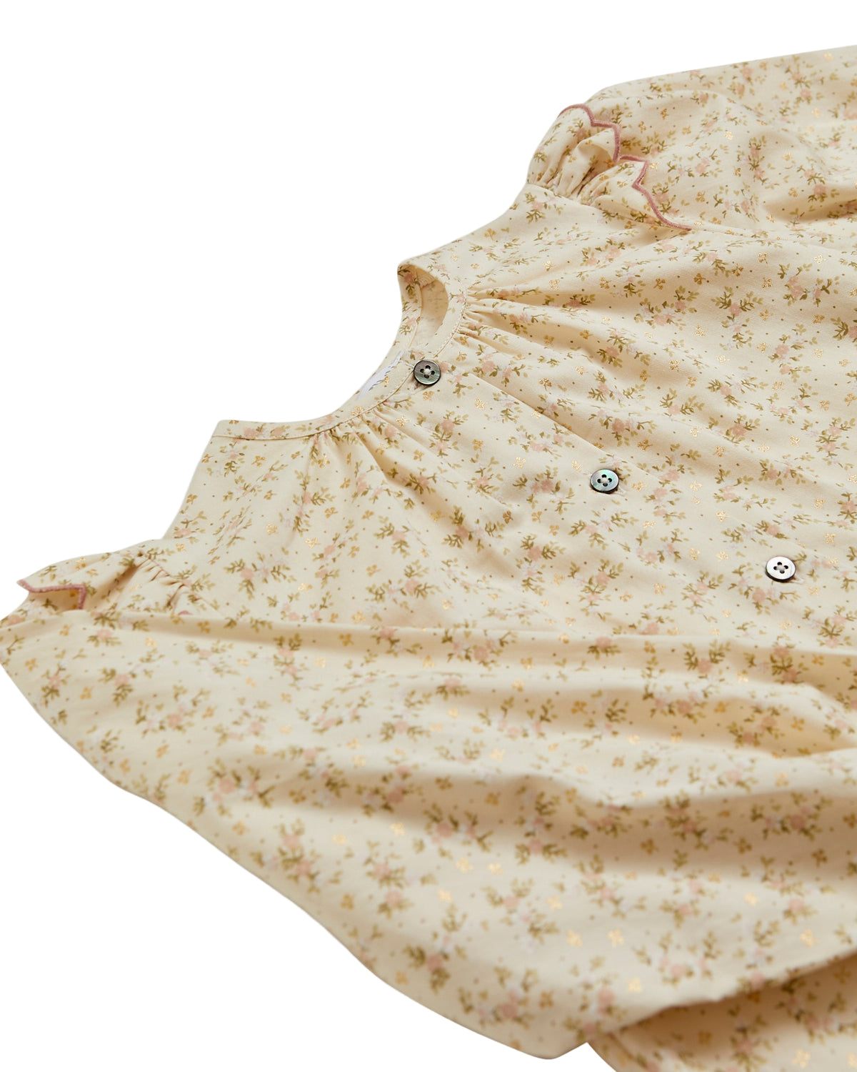 Close-up of a beige quilted jacket with floral pattern on a white background