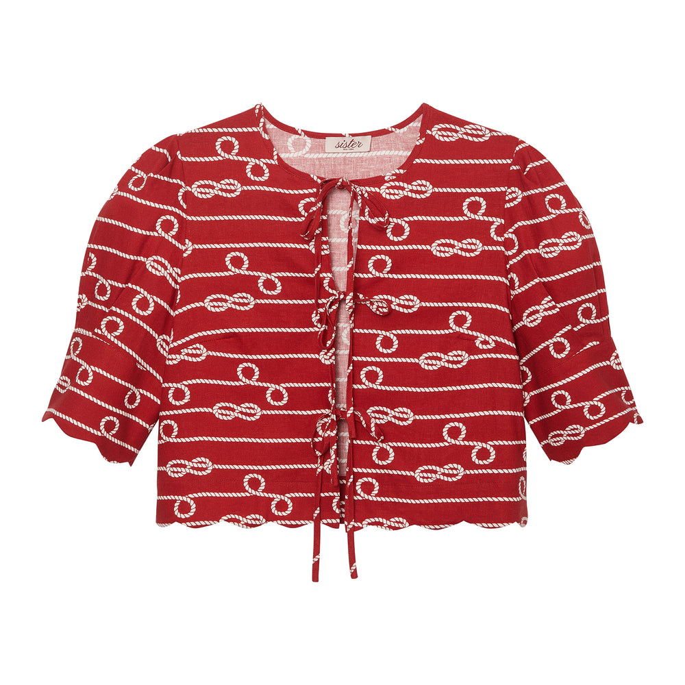 Front of scalloped tie-front crop top in red-and-ivory rope print with scalloped hem and short sleeves on white background