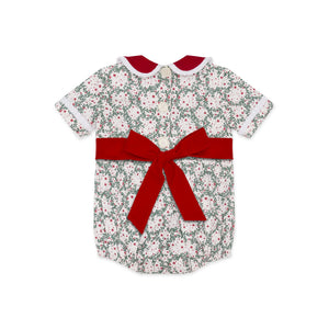 Grace Bubble in Regent Wreaths holiday print with red velvet sash and Peter Pan collar, finished with crisp white pleated trim for baby and toddler girls.