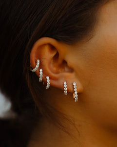 Sparkler Pin Earrings shown on the first hole with Sparkler Huggies layered above., 14k yellow gold, 14k rose gold, 14k white gold