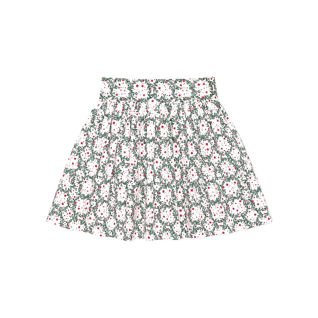 Girls’ Sutton Skirt in Regent Wreaths, featuring a festive green wreath and red star print on white with a full gathered silhouette.