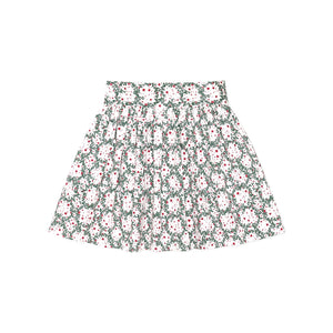 Girls’ Sutton Skirt in Regent Wreaths, featuring a festive green wreath and red star print on white with a full gathered silhouette.