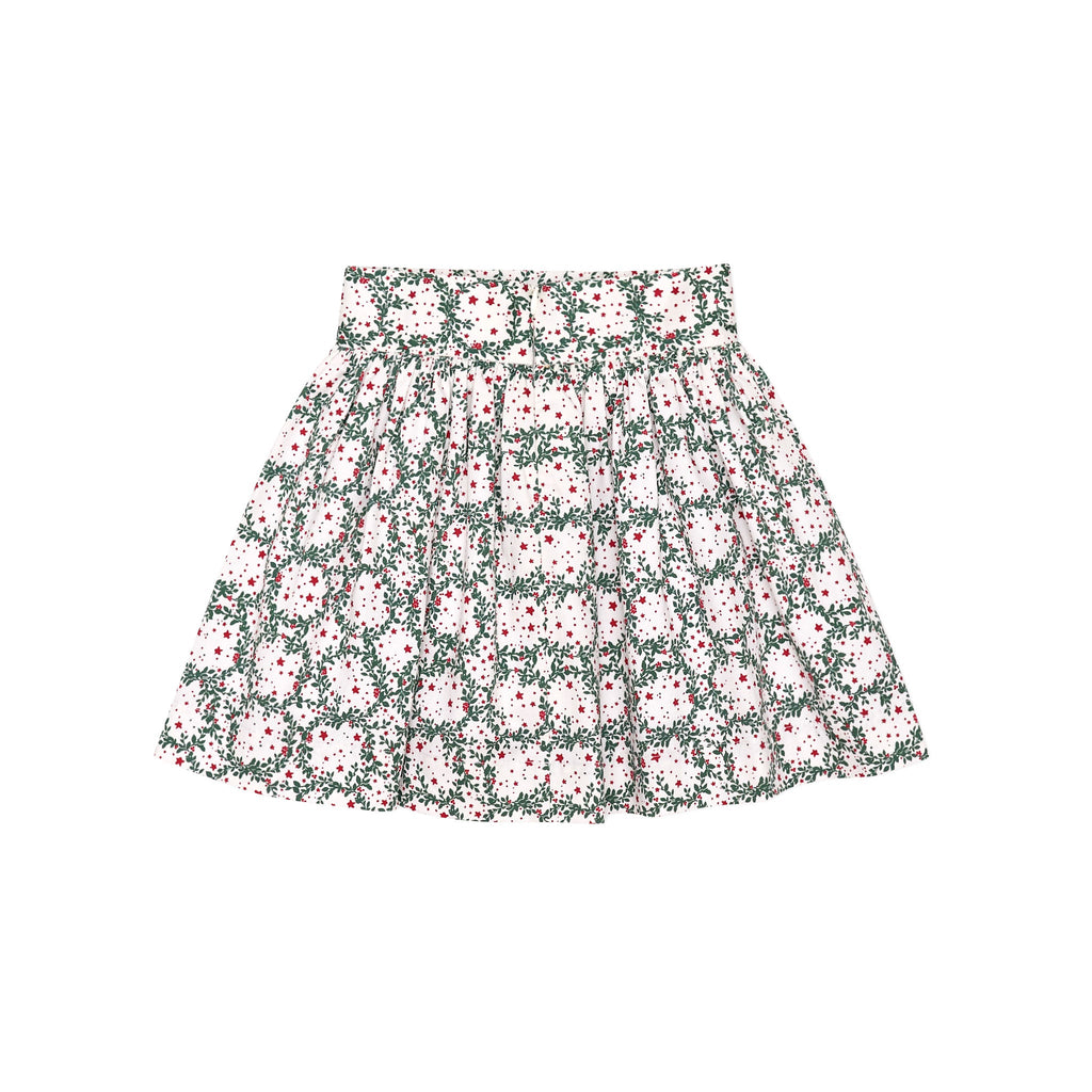 Girls’ Sutton Skirt in Regent Wreaths, featuring a festive green wreath and red star print on white with a full gathered silhouette.