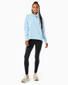 Model is wearing the Everyday Pullover in Baby Blue with the Chestnut Legging in Black