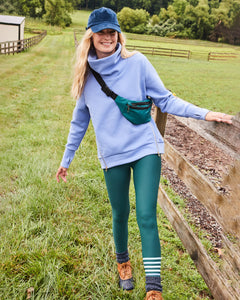 Model is wearing the Everyday Pullover in Violet and the Everyday Legging in Ivy