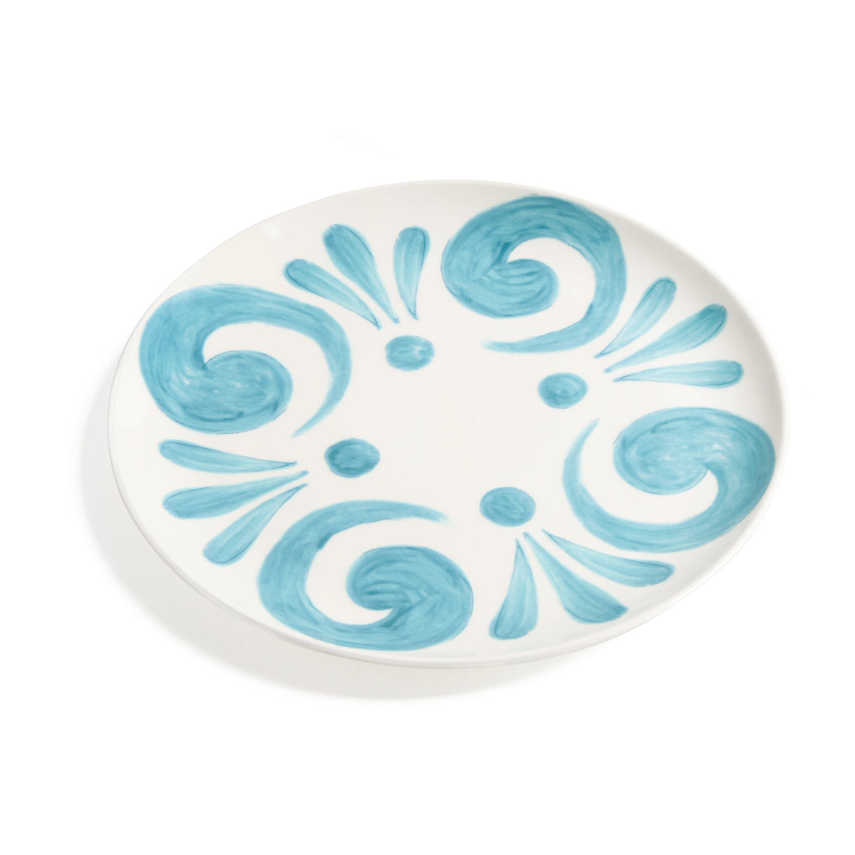 Angled view of Kallos Aqua Charger Plate showcasing hand-painted aqua pattern on white porcelain with a white background