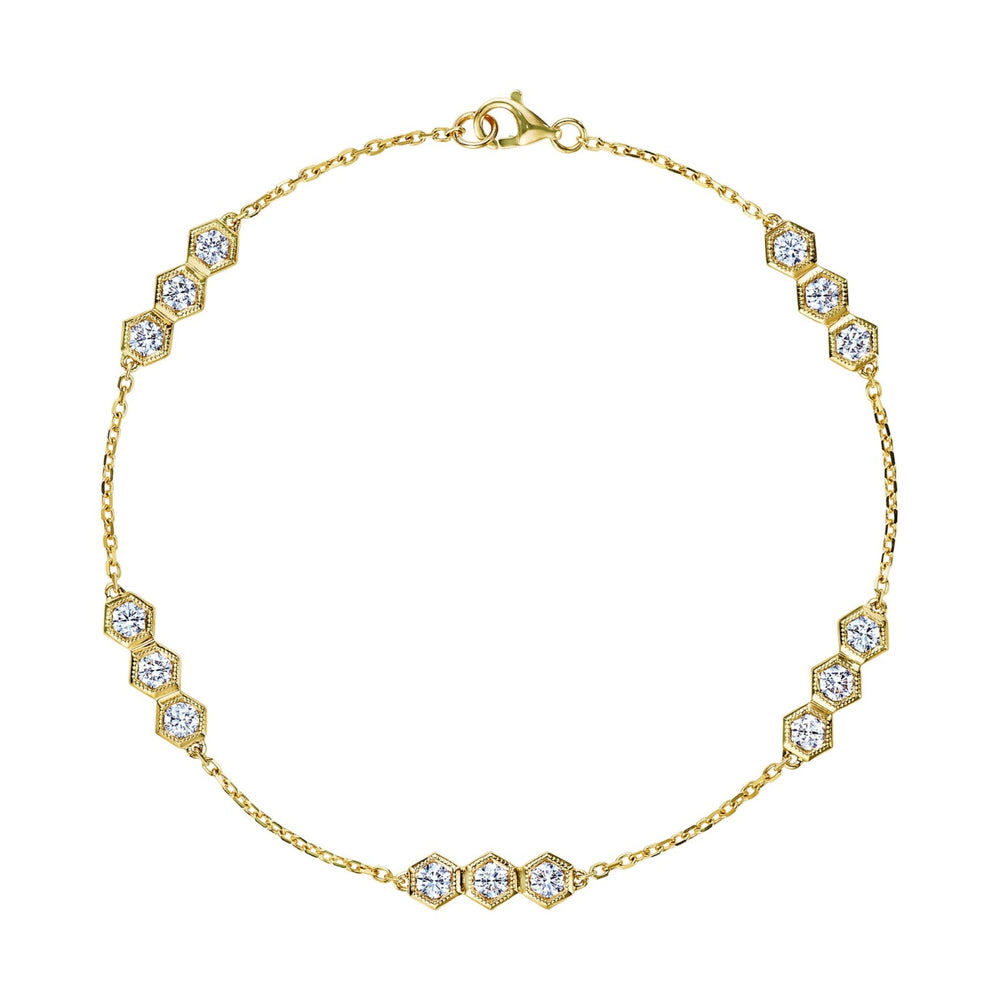 The Serpentine Station Bracelet with Hexagon Diamond Trios is an 18k gold bracelet featuring small hexagonal clusters of round brilliant diamonds, evenly spaced along a fine chain with a lobster claw clasp.