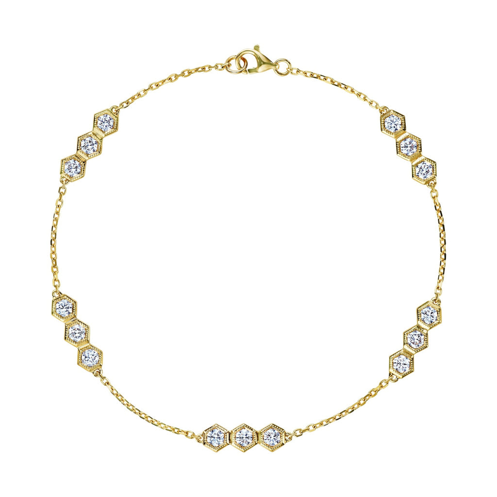 The Serpentine Station Bracelet with Hexagon Diamond Trios is an 18k gold bracelet featuring small hexagonal clusters of round brilliant diamonds, evenly spaced along a fine chain with a lobster claw clasp.