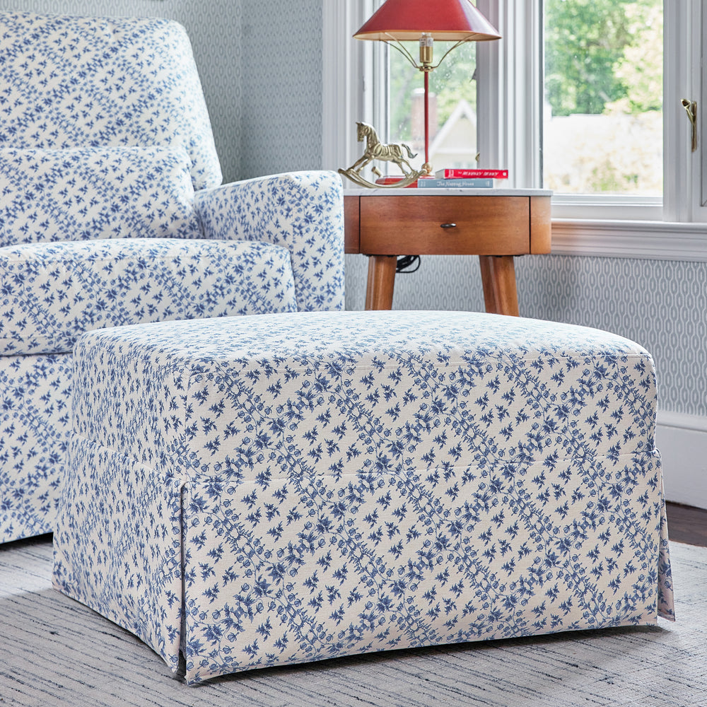 Front view of Sarah Flint x Namesake Crawford ottoman in blue lattice eco-weave with matching glider and side table