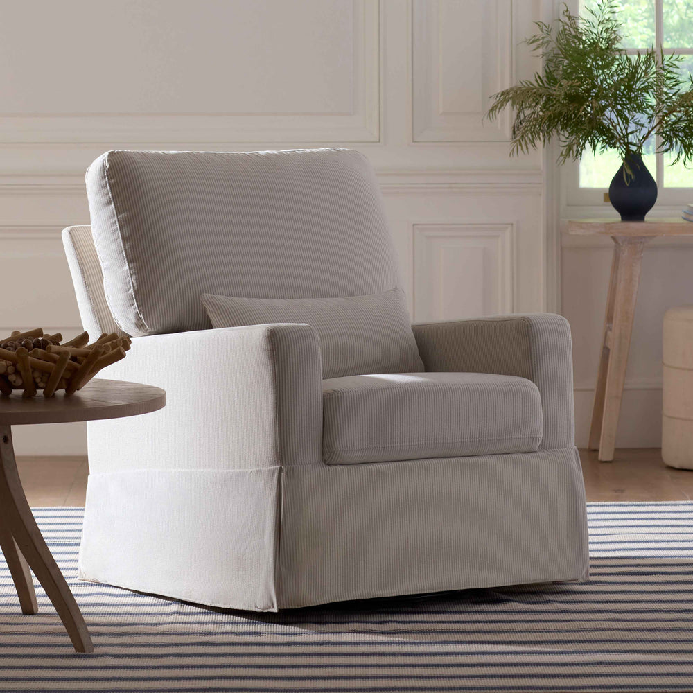 Three-quarter view of Crawford Pillowback Comfort swivel glider in Fog Chatham Stripe with lumbar pillow and skirted base