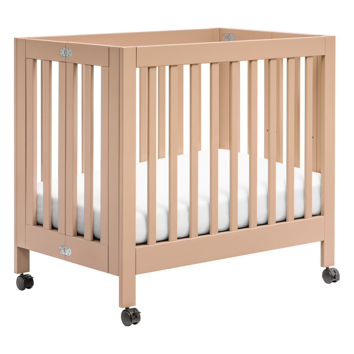 Three-quarter view of Origami Mini Crib in Canyon showing caster wheels, fold latches, and white mattress on white background
