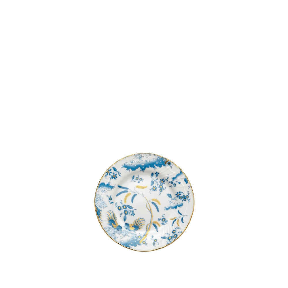 Top view of Oro Di Doccia bread plate showcasing blue floral and rooster pattern with gold rim on white background