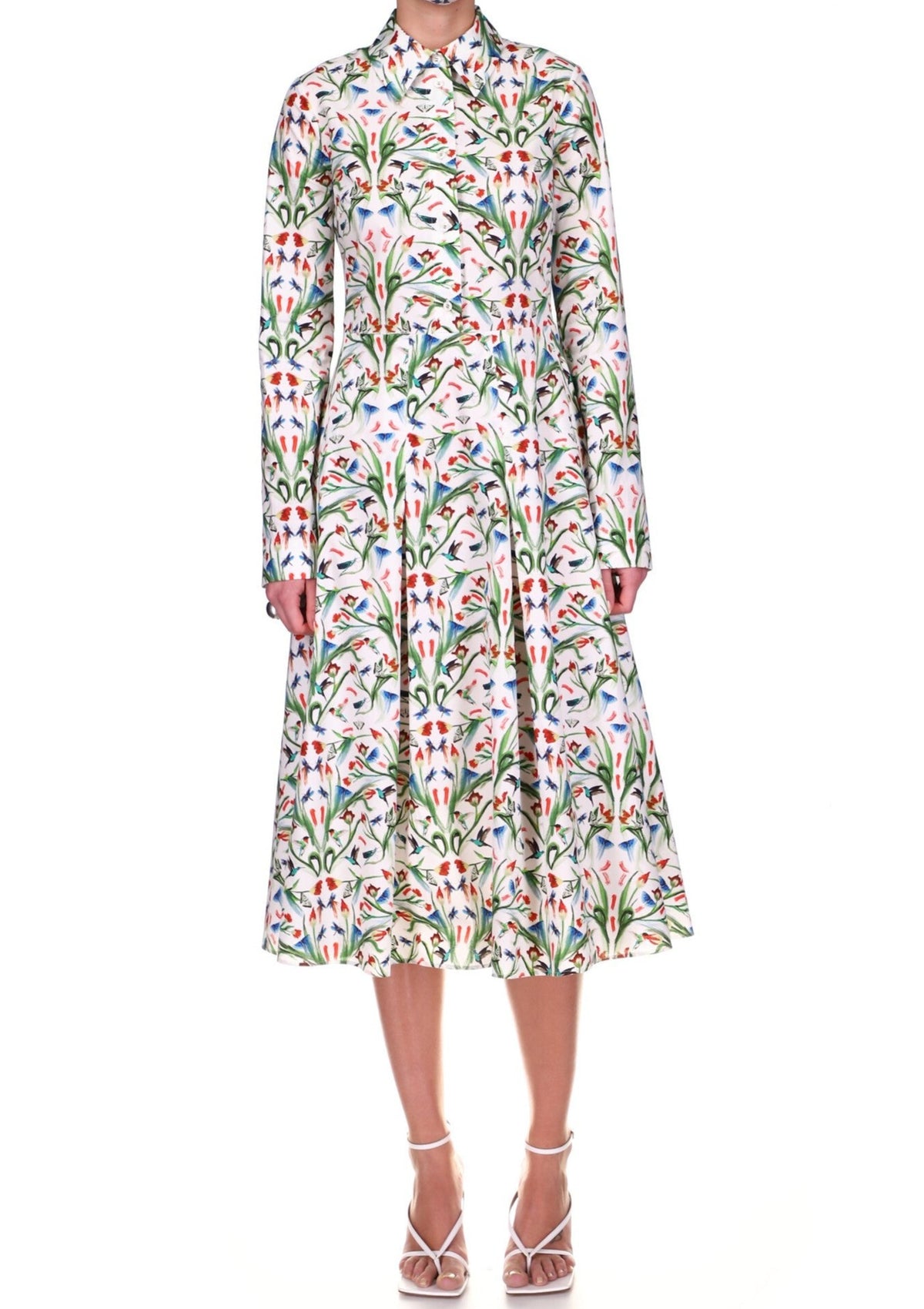 Front view of long-sleeve shirt dress in Critter Garden Party cotton with collared bodice and pleated midi skirt on white
