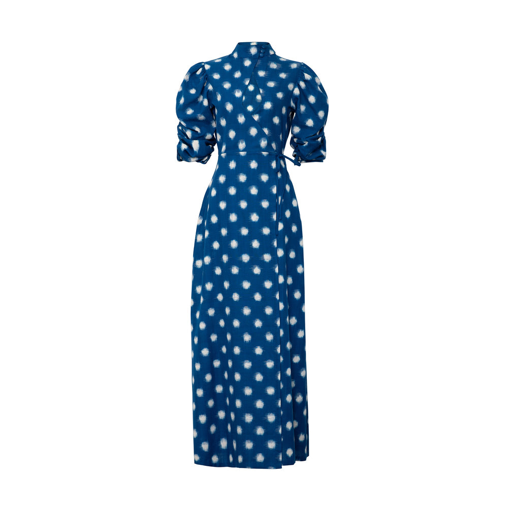 Front view of Campo Dress in Blue showcasing wrap style, polka dot print, and gathered puff sleeves on a white background