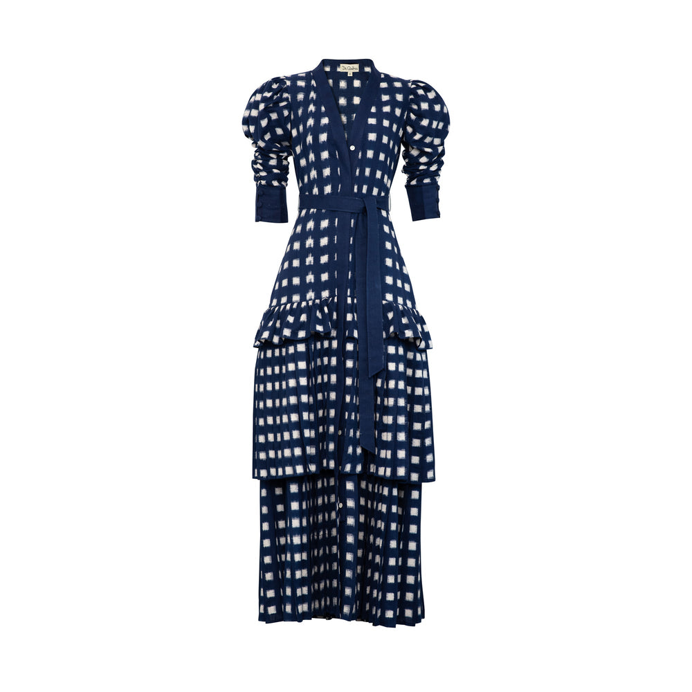 Front view of Lapis Lazuli Dress with navy blue and white double ikat, puff sleeves, pleated skirt, and belt on white backdrop