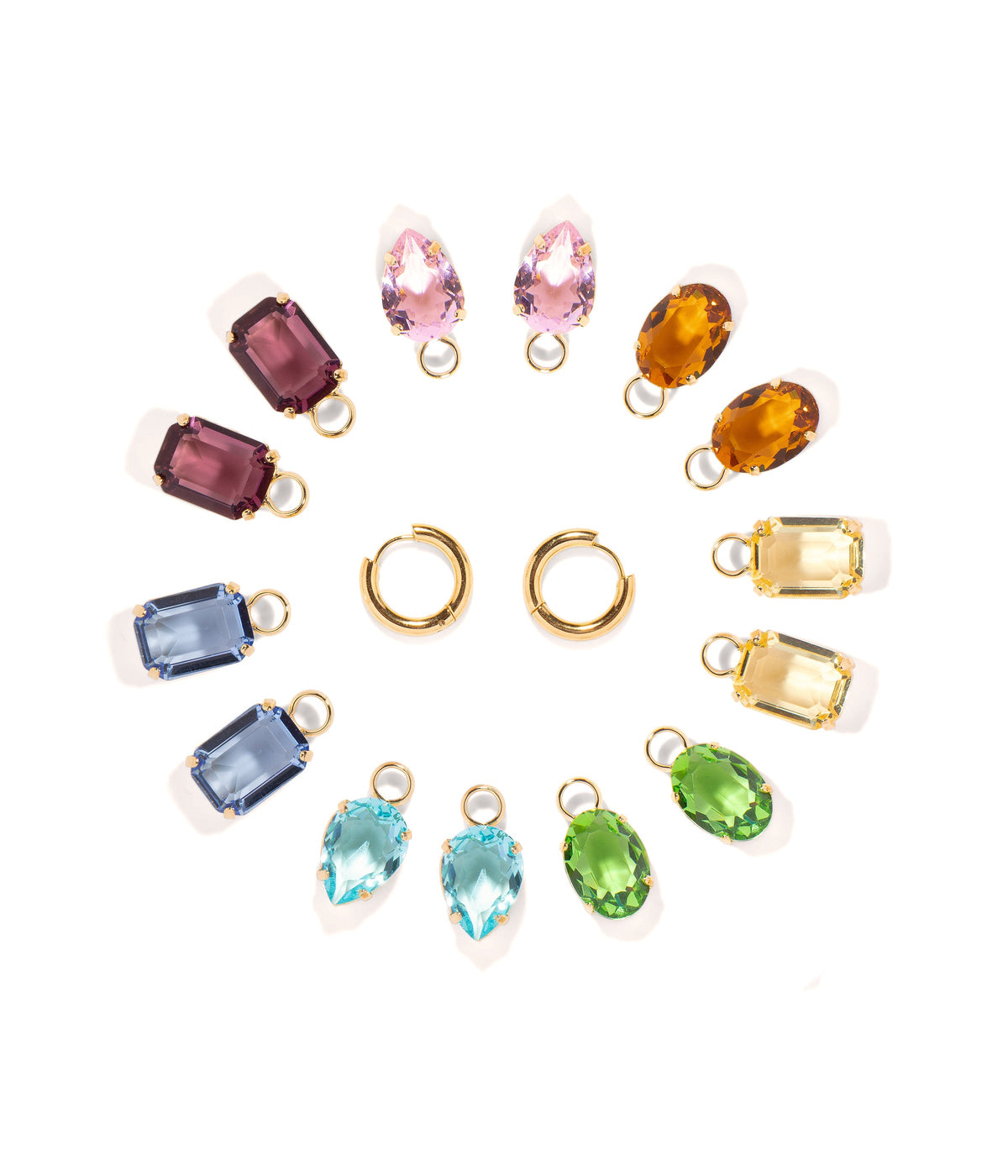 Top view of Over the Rainbow Earring Set showcasing rainbow colored glass charms and gold hoops on a white background