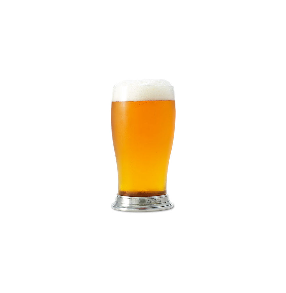 Front view of Match pint glass showcasing pewter base and amber beer on white background