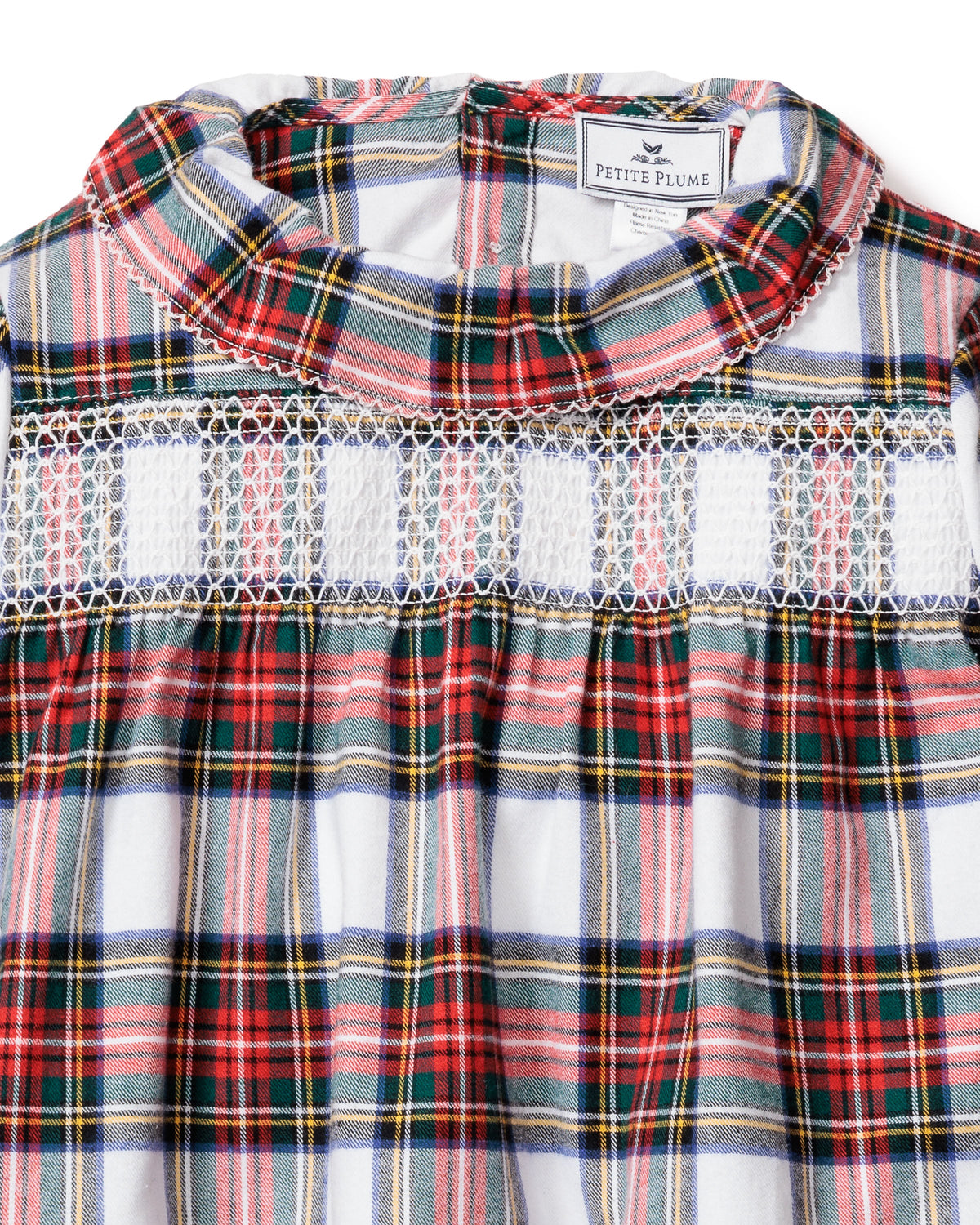 Close-up front of children’s Balmoral Tartan Eloise nightgown showcasing smocked yoke, ruffled collar and Petite Plume label on white background
