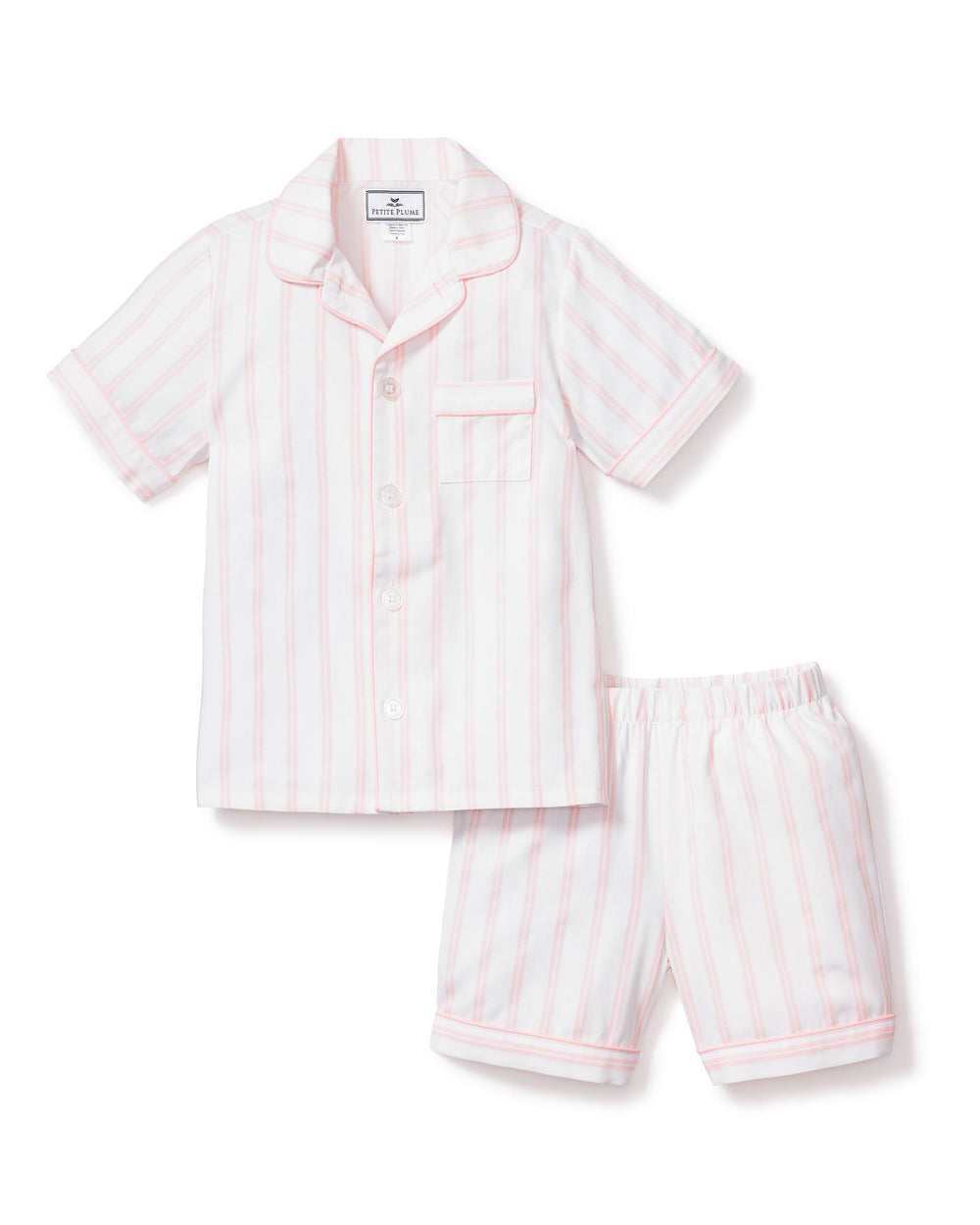 Flat-lay of kids’ pink and white striped short pajama set with button-front top and elastic-waist shorts on white background