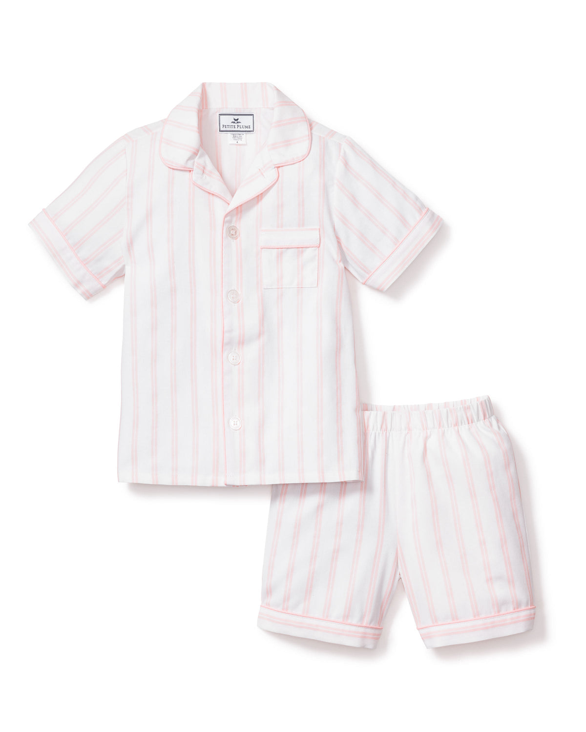 Flat-lay of kids’ pink and white striped short pajama set with button-front top and elastic-waist shorts on white background