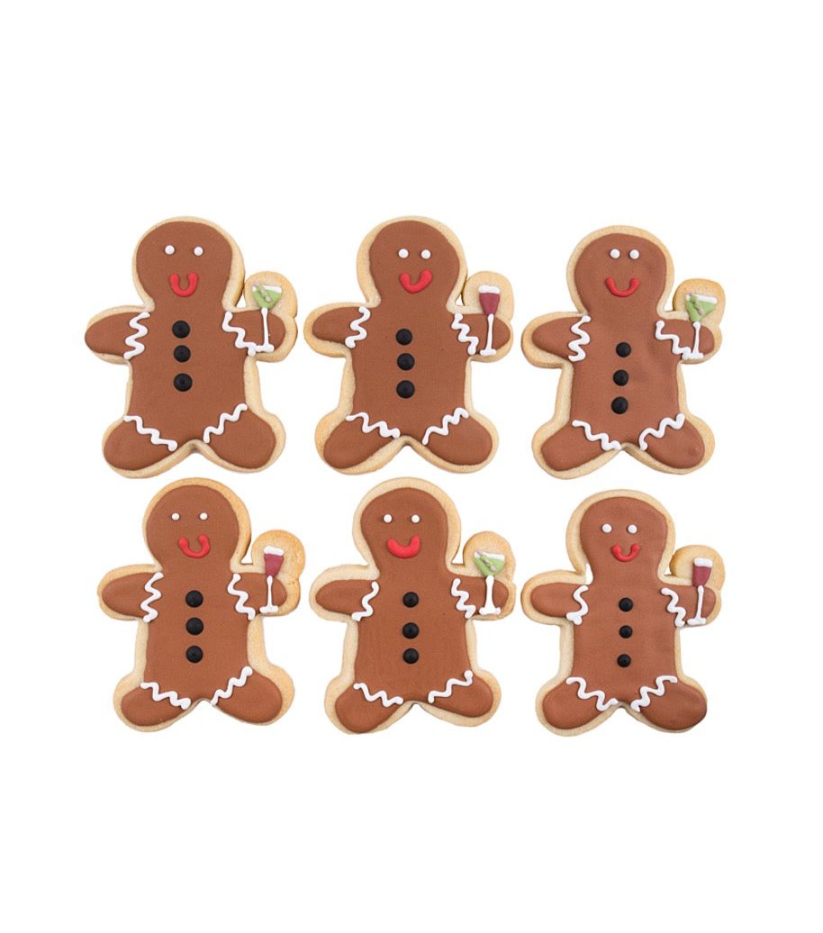 Front view of set of six gingerbread man sugar cookies showcasing royal icing details and each holding a wine or martini glass on white background