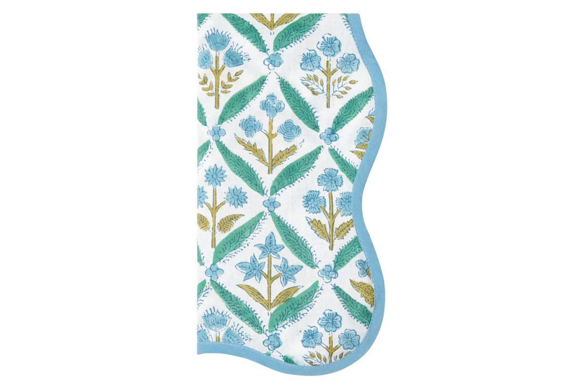 Front view of The Delfina Napkin showcasing a teal, sky blue, and faint green floral pattern with a white background