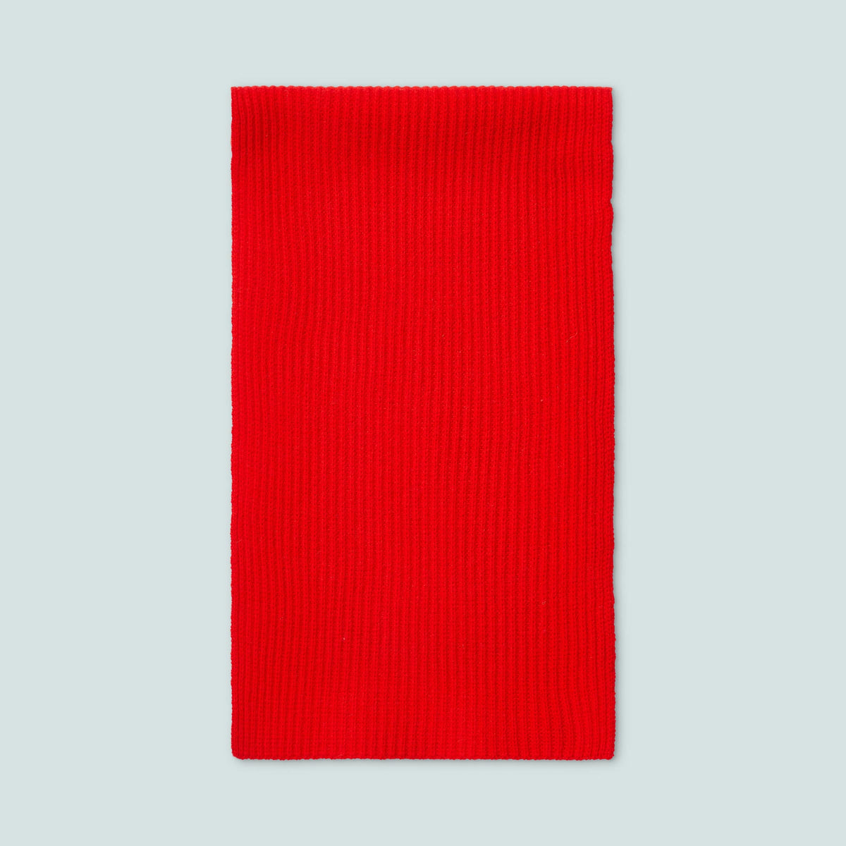Front view of Color Block Scarf in Red and Pink showcasing chunky vertical ribs on a light gray background