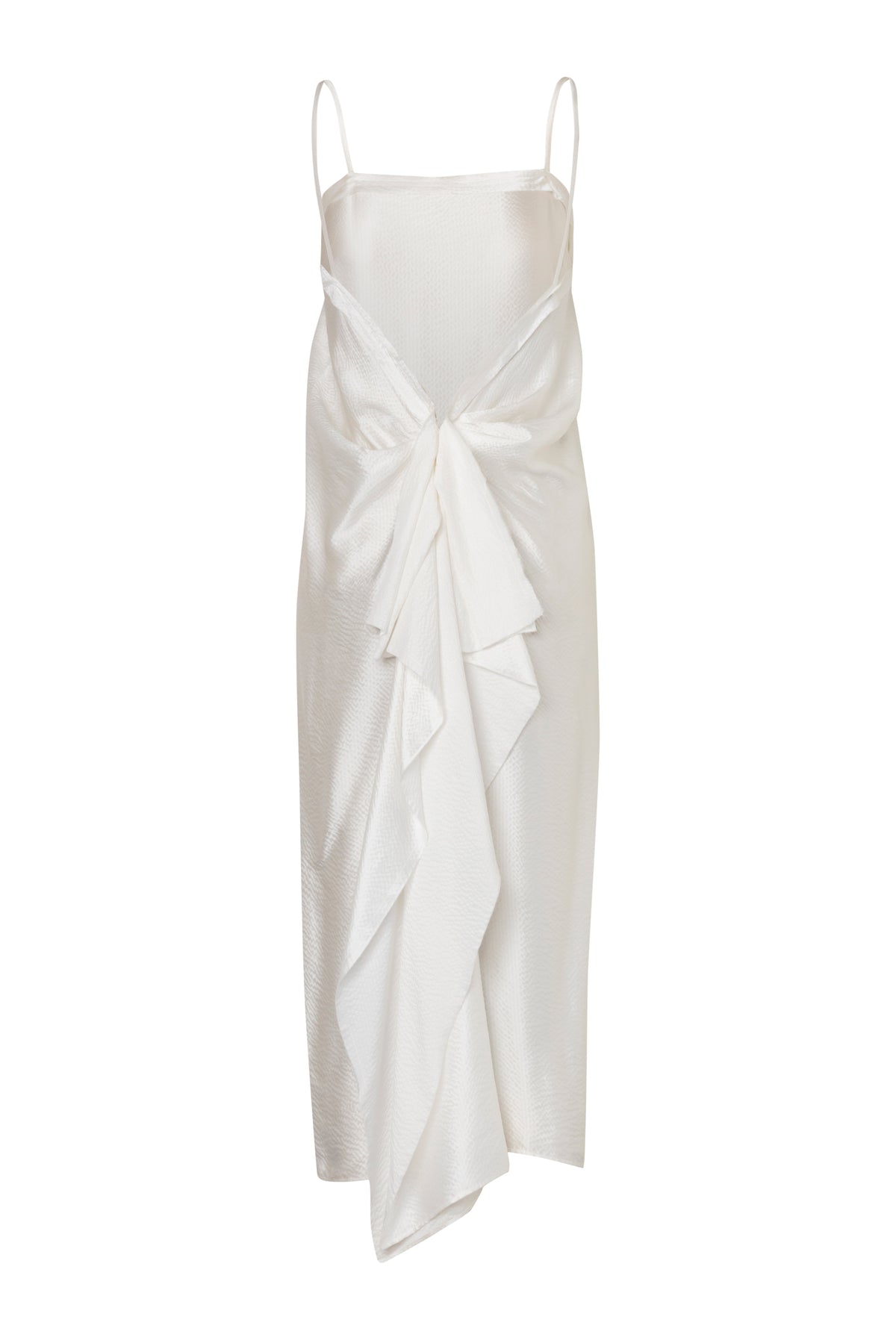 Rear view of the white silk-satin Knot Dress showcasing dramatic lower-back knotting and thin straps against a white background