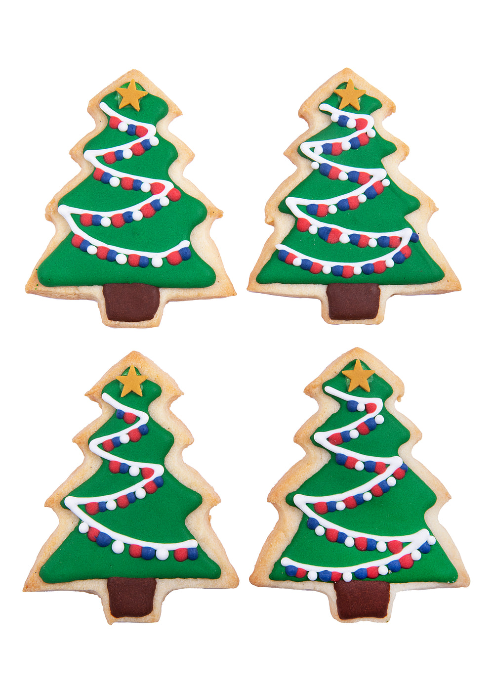 Top-down view of tree-shaped sugar cookies with green icing, white garlands, red and blue dot sprinkles on white background