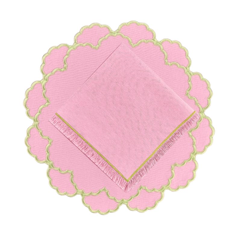 pink scalloped placemat with green embroidery with coordinating fringe napkin