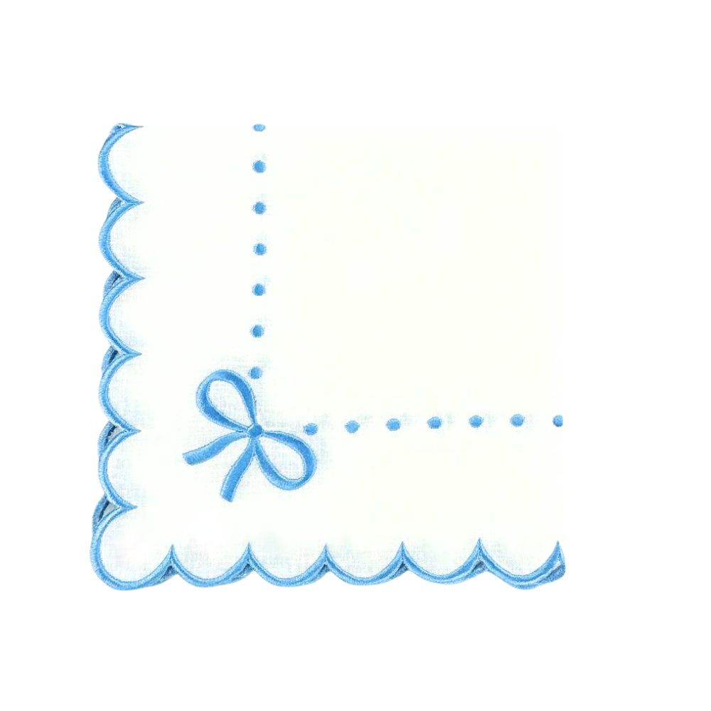 Close-up of Juliet Bows napkin showcasing blue silk-embroidered bows, dots, and scalloped border on white linen