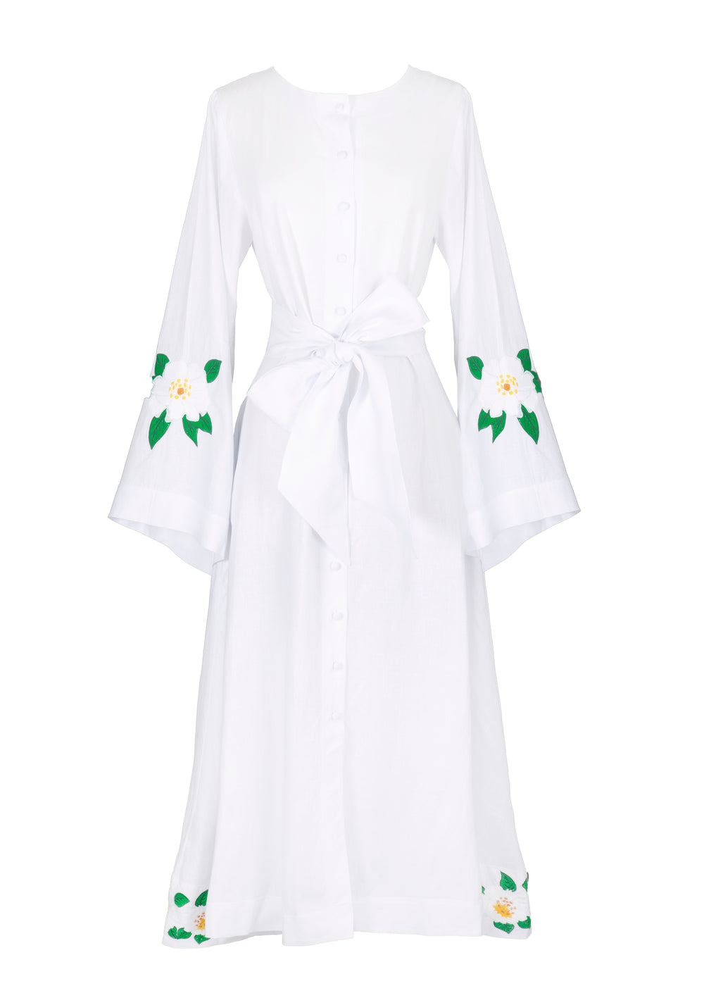 Front view of Jama Dress showcasing white linen dress with button front, waist tie, loose long sleeves and floral embroidery