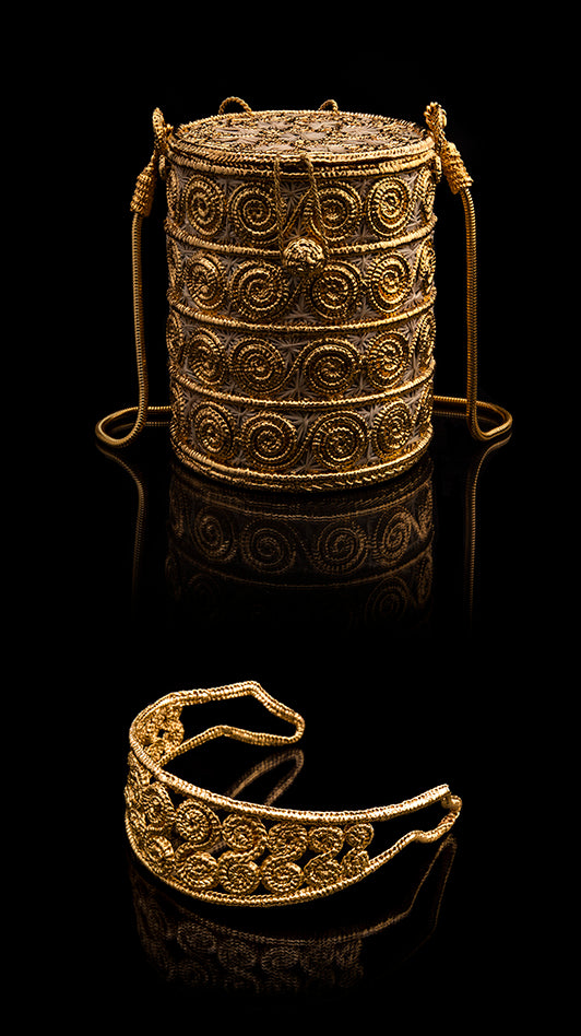Close-up of Spiral Headband showcasing gold accents and ornate spiral detailing with black background